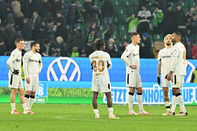 Leverkusen players stand on the pitch after the German Bundesliga soccer match with VfL Wolfsburg at Volkswagen Arena on Saturday. Photo: Swen Pförtner/dpa.